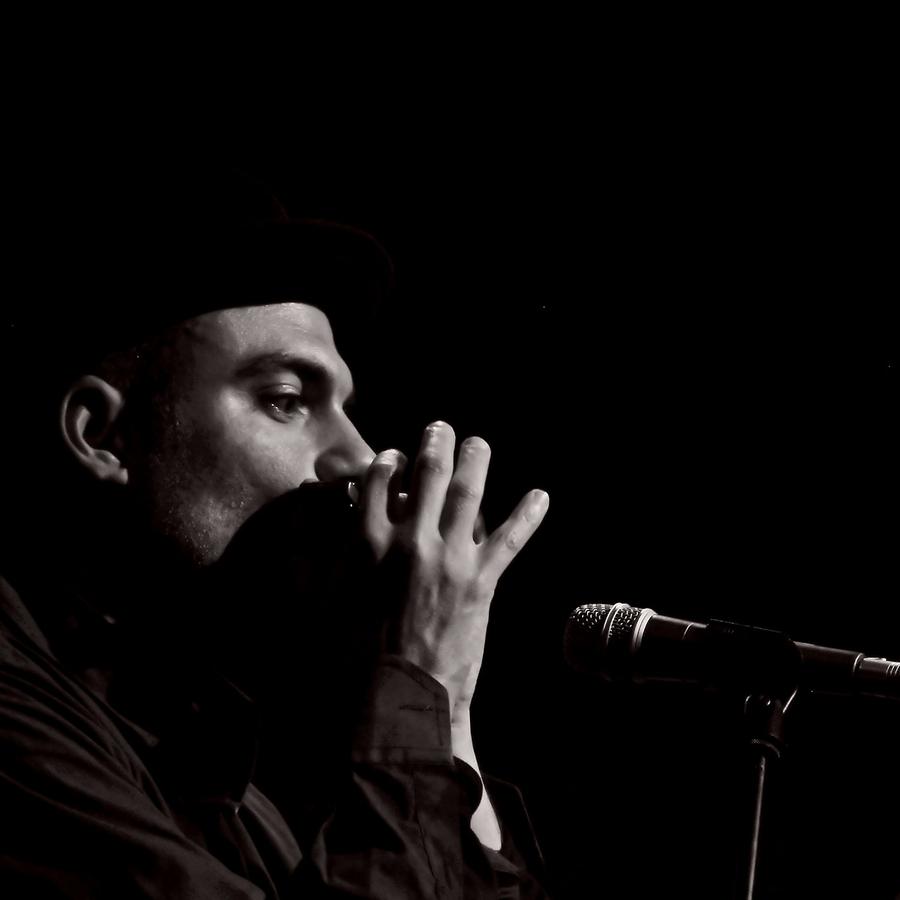 Marco Farris playing harmonica close to the microphone