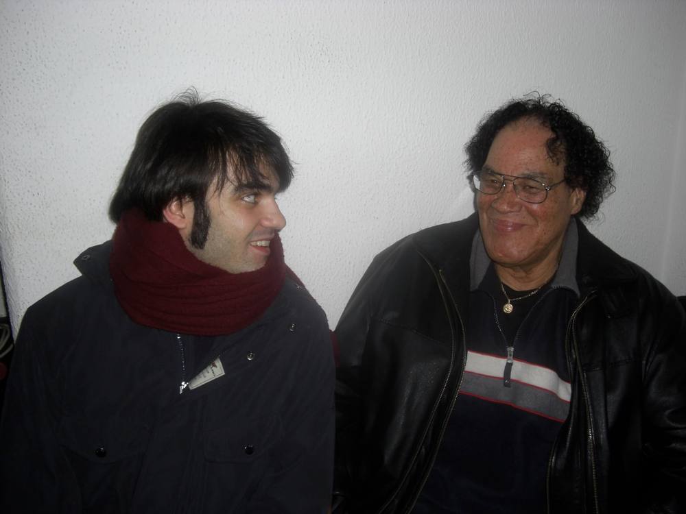 Marco Farris smiling backstage with a fellow musician